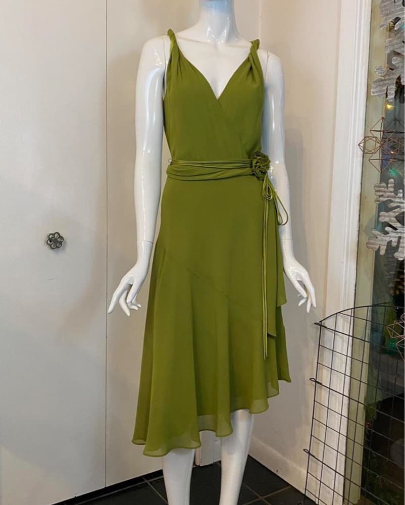 Vibrant Green Wrap Dress with Floral Accent - Image 1